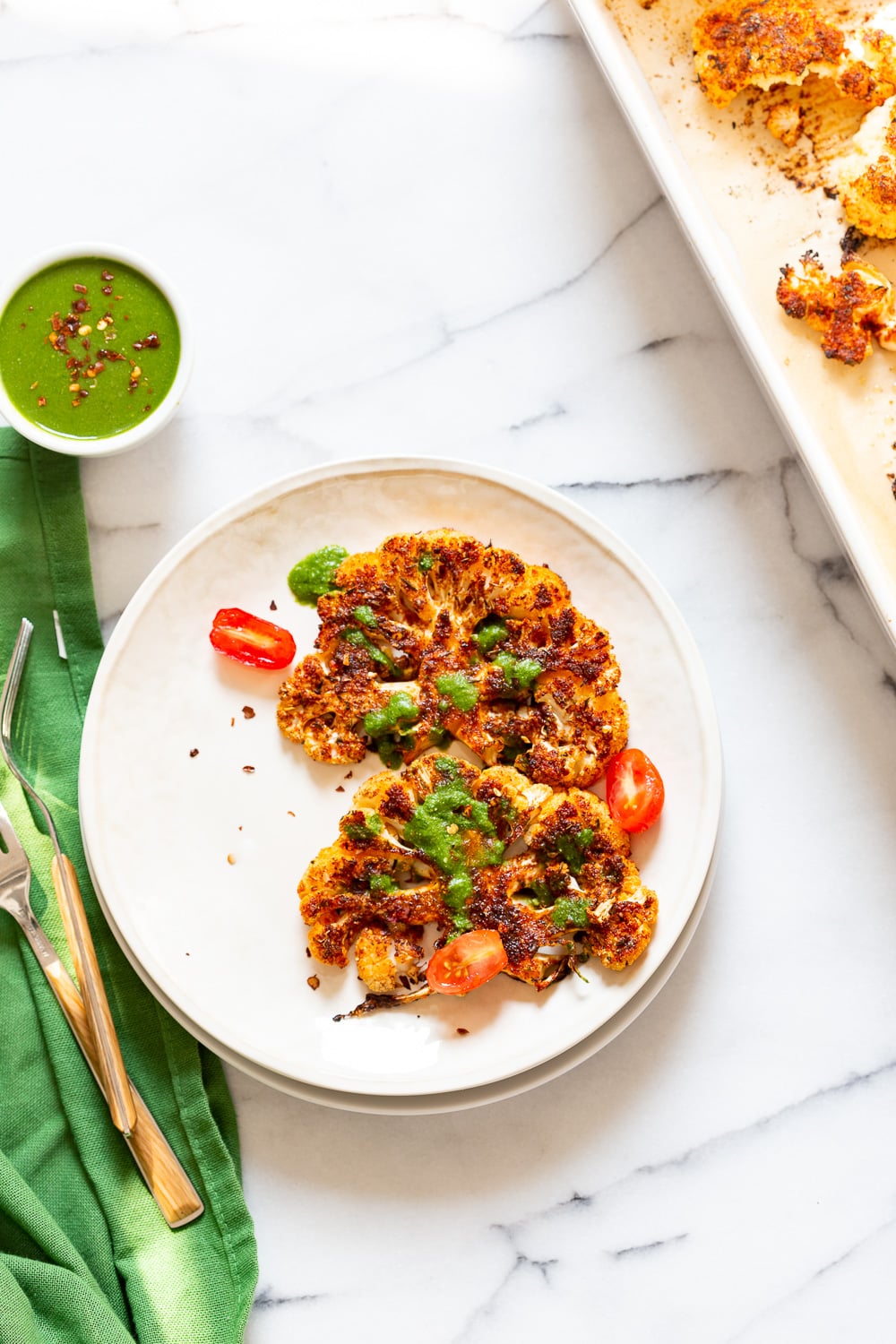 Vegan Cajun Roasted Cauliflower "Steaks" with Chimichurri Sauce. Slice into thick slices or just chop into florets to make this delicious Cajun Cauliflower. Serve with chimichurri or a cooling dressing. #Vegan #Glutenfree #Soyfree #Nutfree #Recipe #veganRicha #cajunCauliflower