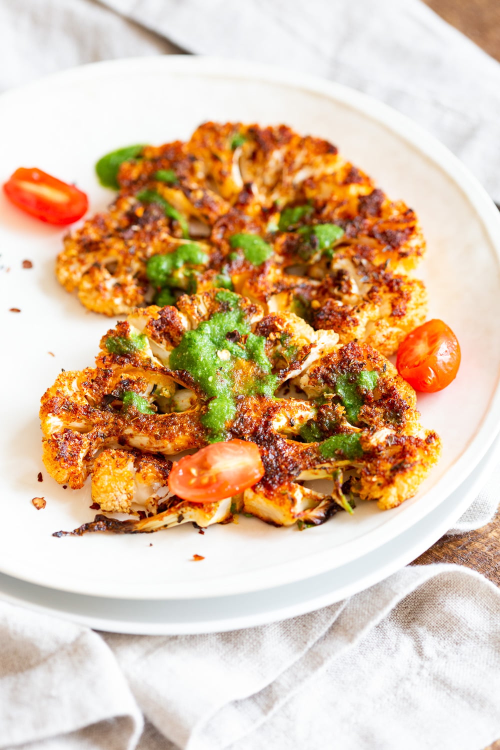Vegan Cajun Roasted Cauliflower "Steaks" with Chimichurri Sauce. Slice into thick slices or just chop into florets to make this delicious Cajun Cauliflower. Serve with chimichurri or a cooling dressing. #Vegan #Glutenfree #Soyfree #Nutfree #Recipe #veganRicha #cajunCauliflower