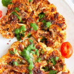 Vegan Cajun Roasted Cauliflower "Steaks" with Chimichurri Sauce. Slice into thick slices or just chop into florets to make this delicious Cajun Cauliflower. Serve with chimichurri or a cooling dressing. #Vegan #Glutenfree #Soyfree #Nutfree #Recipe #veganRicha #cajunCauliflower