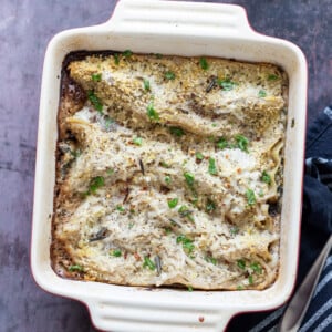 Easy Creamy Vegan Mushroom Lasagna. Marinated and baked Portobello mushrooms layered between creamy garlic sauce and lasagna sheets to make a hearty portobello lasagna. #Vegan #Recipe #veganmushroomlasagna #portobelolasagna #veganricha Can be Glutenfree