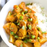 a serving of Indian Aloo Matar Pea and Potato Curry with a side of rice