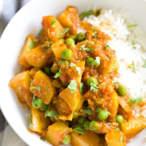 a serving of Indian Aloo Matar Pea and Potato Curry with a side of rice