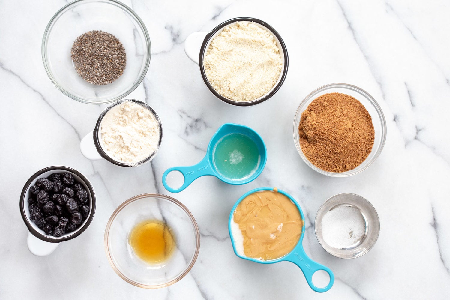Ingredients for our Blueberry Muffin Energy Bites in bowls and measuring cups