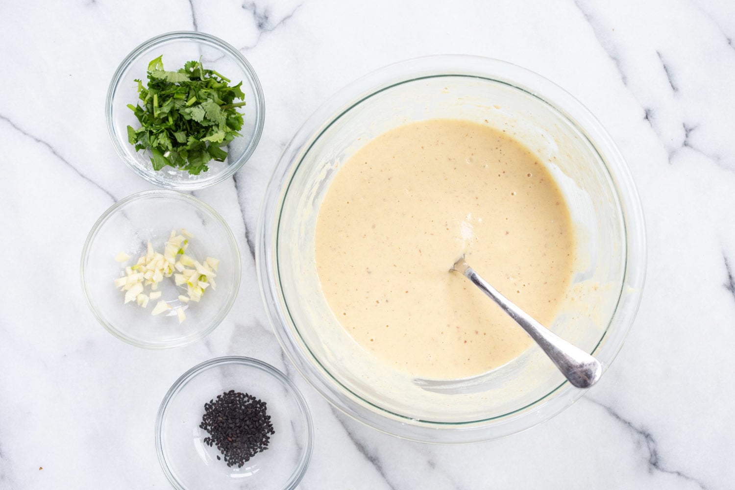 Batter for our Vegan Gluten Free Naan with garnishes in bowls