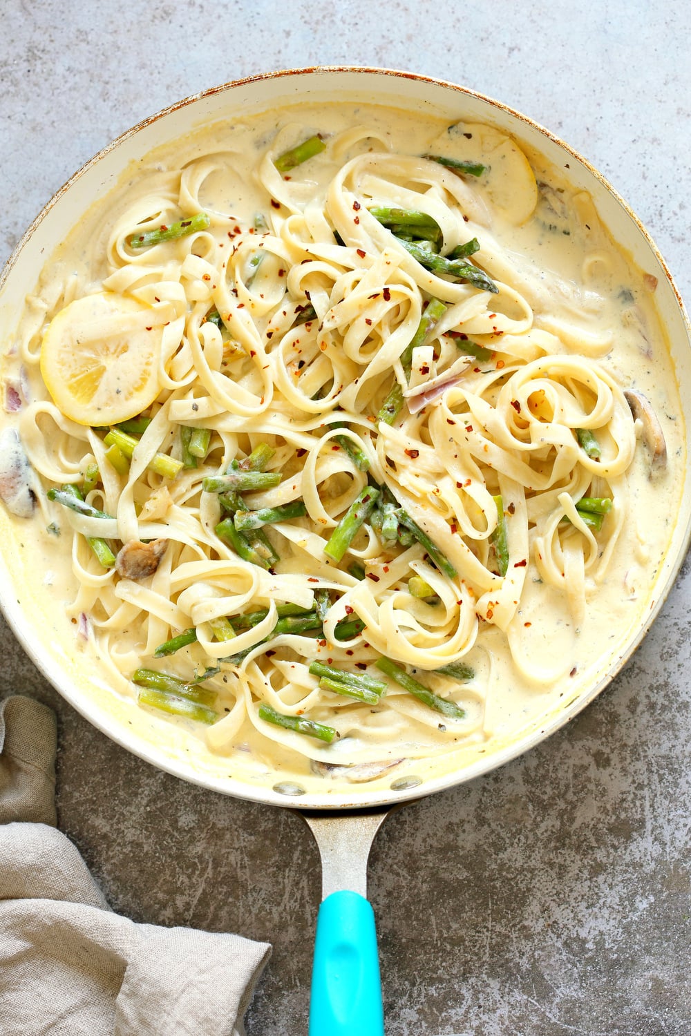 Vegan Lemon Asparagus Pasta - 30 mins! Creamy Lemon Alfredo style sauce with tofu with fettuccine and pan roasted garlic asparagus and more lemon. #Vegan #Nutfree #Recipe. Can be Glutenfree #VeganRicha #LemonAsparagusPasta 17 gm of protein