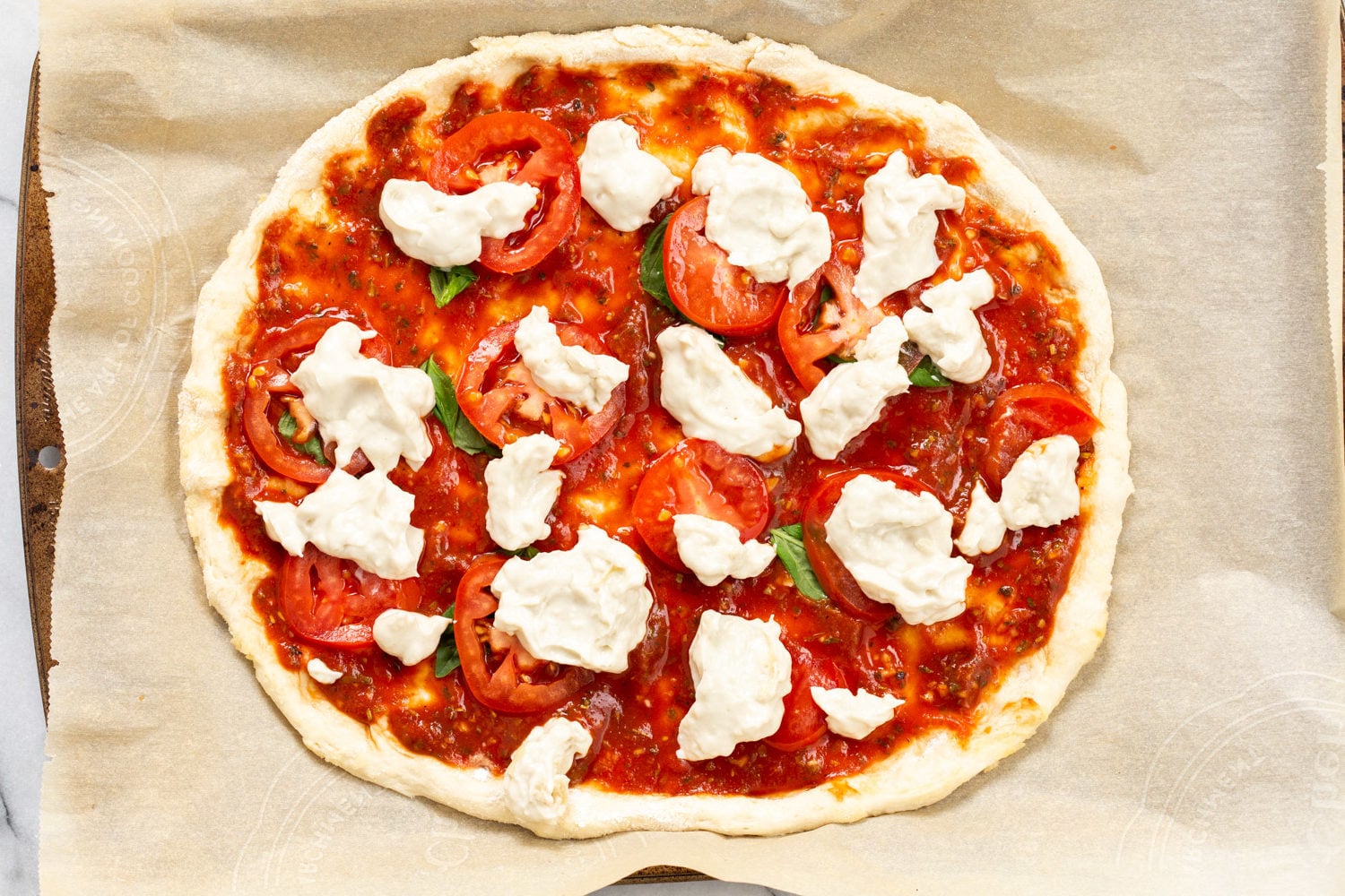 Our Vegan Margherita Pizza on parchment
