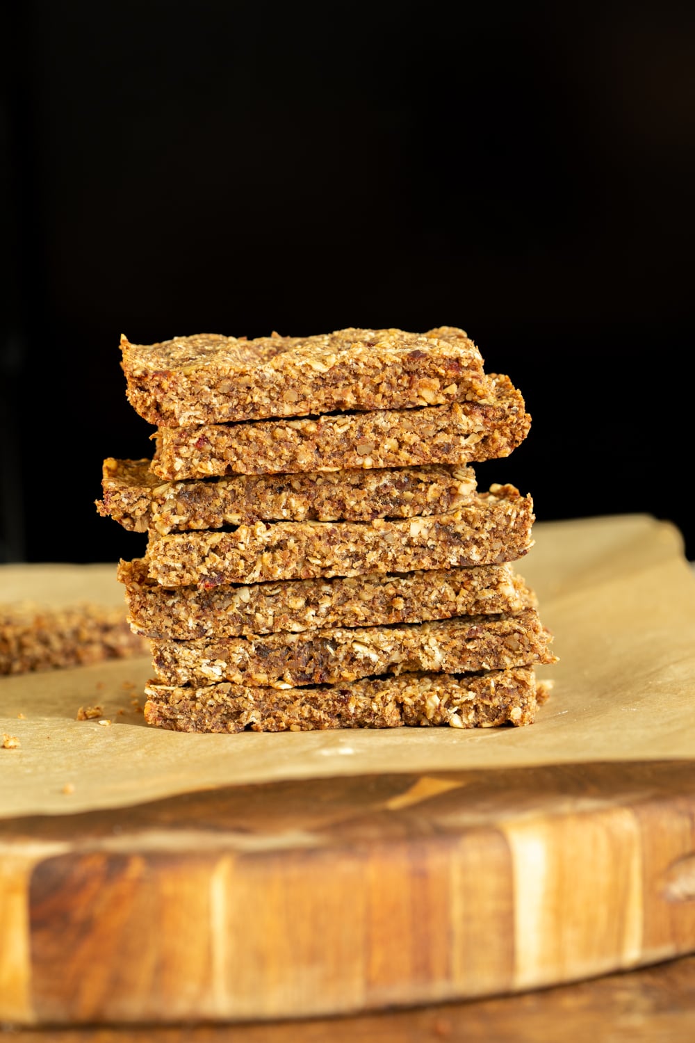 vegan granola bars a stack of vegan caramelized banana & nut granola bars against a black background