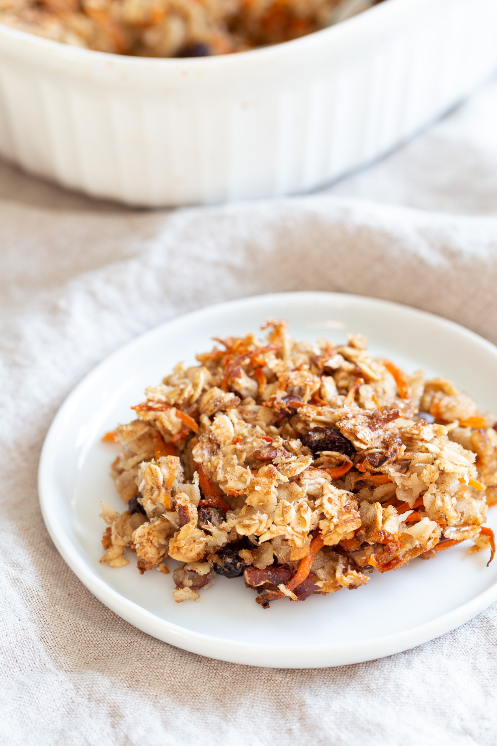 This Vegan Carrot Cake Baked Oatmeal has roasted carrots,, spices, nuts, dates and Oats! Crisp on the outside and spiced, delicious carrot cake like inside. #refinedoilfree #Vegan #Soyfree #Recipe #VeganRicha #carrotcakeoatmeal #carrotcakebakedoatmeal Easily nutfree, #glutenfree