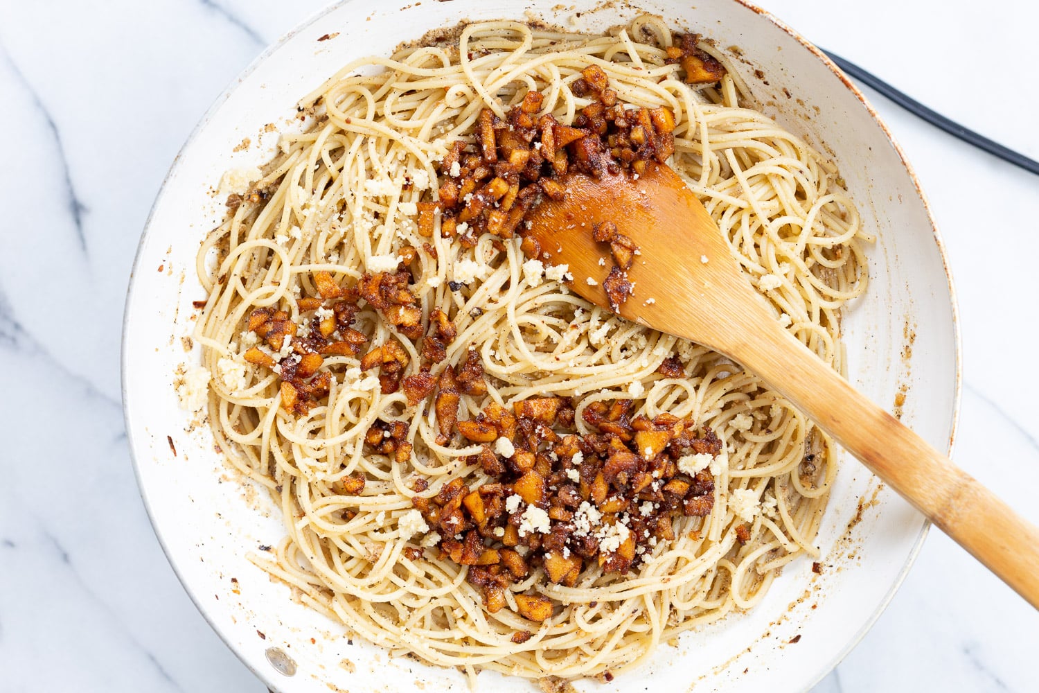 Our Vegan Cacio e Pepe with Smoky Balsamic Chickpea Tofu Bits in a white skillet
