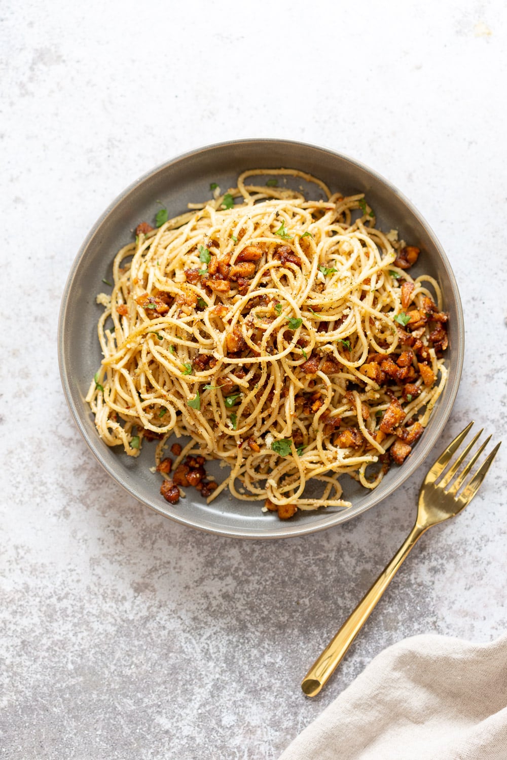 Our Vegan Cacio e Pepe with Smoky Chickpea Tofu Bits in grey Bowl