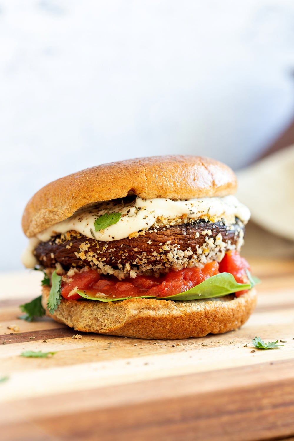 Vegan Portobello Mushroom Burger. Portobello marinated and stuffed with vegan mozzarella, then breaded to make Crispy Portobello Sandwiches! Top with more vegan mozzarella cream, fresh herbs. #Vegan #Recipe #VeganRicha #VeganPortobelloMushroomBurger #breadedportobello. Nutfree Gluten-free options