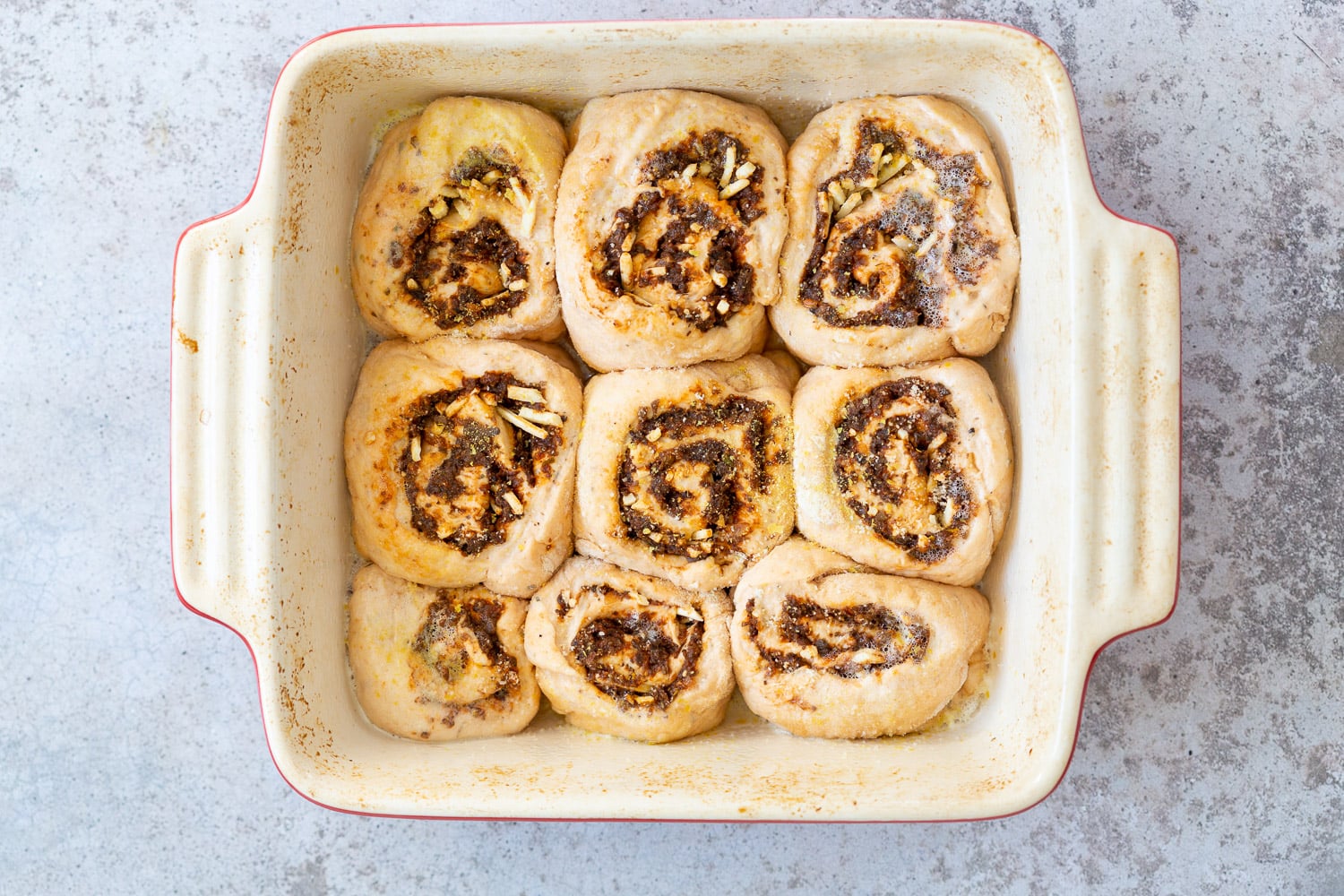 Vegan Pizza Rolls ready to bake in a ceramic baking dish