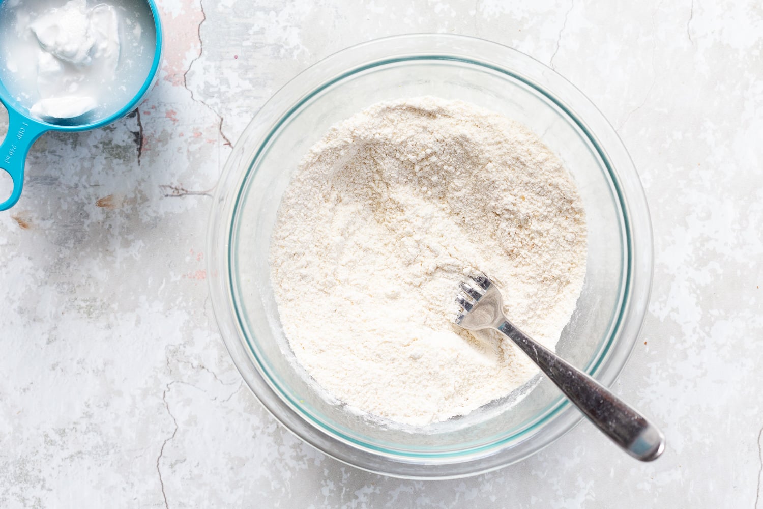 Dry ingredients in a glass bowl for the biscuit topping of our vegan Blueberry cobbler