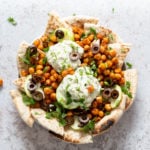 Mediterranean Nachos with Shawarma Chickpeas, Tzatziki, Olives, Cucumber, warm toasted Pita bread. Great Appetizer for parties or potluck. #Vegan #Veganricha #Mediterraneannachos