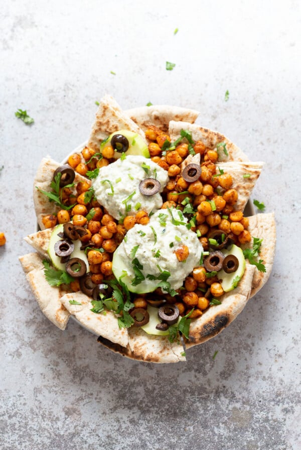 Mediterranean Nachos with Shawarma Chickpeas, Tzatziki, Olives, Cucumber, warm toasted Pita bread. Great Appetizer for parties or potluck. #Vegan #Veganricha #Mediterraneannachos