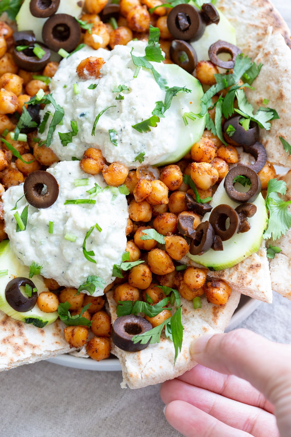 Vegan Mediterranean Nachos with Shawarma Chickpeas, Tzatziki, Olives, Cucumber, warm toasted Pita bread. Great Appetizer for parties or potluck. #Vegan #nutfree #recipe #Veganricha #Mediterraneannachos