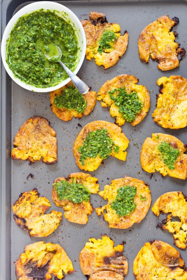Crispy Vegan Smashed Potatoes with Chimichurri. These Smashed potatoes are baked to a crisp and served with fresh homemade parsley chimichurri. #VeganRicha #VeganSmashedPotatoes #Vegan #Glutenfree #Nutfree #Soyfree #Recipe
