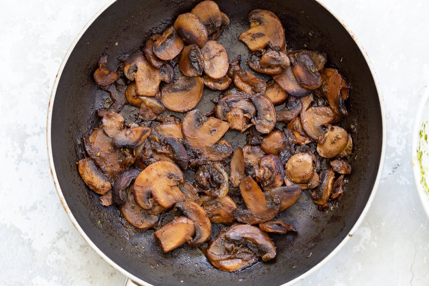 pizza rolls recipe mushrooms sauteeing in a black pan