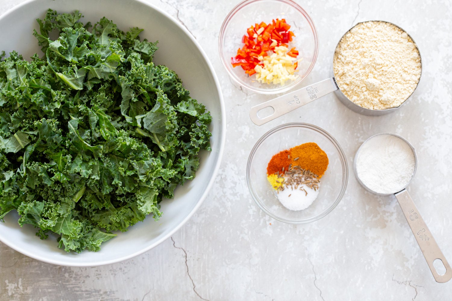 Ingredients laid out for Kale Pakora in bowls