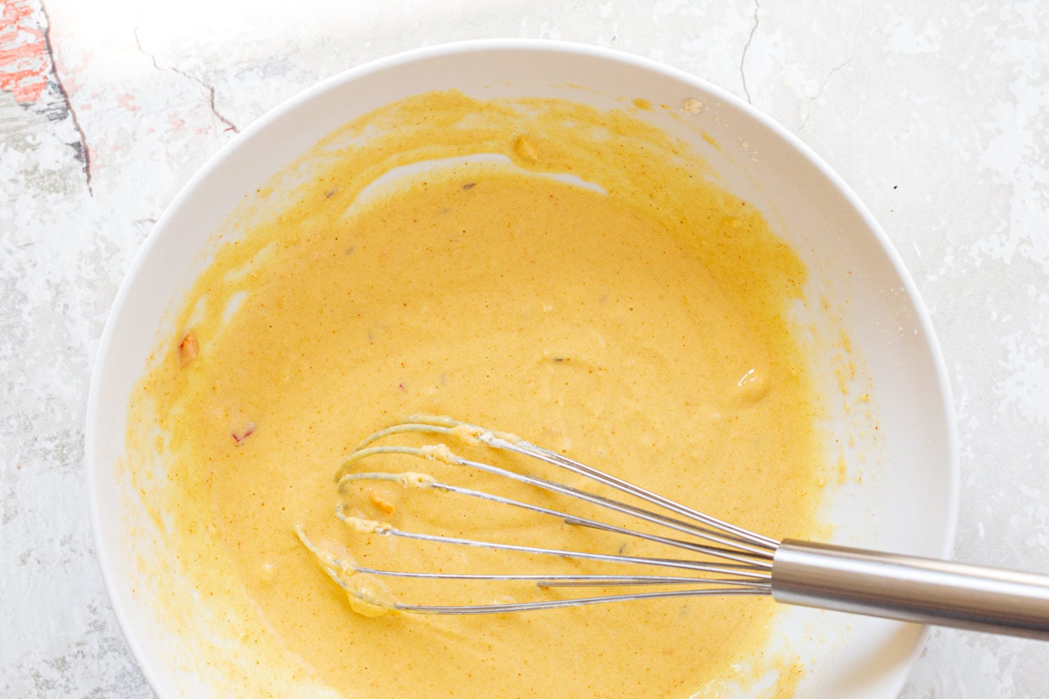 Batter for our Kale Pakora in a white bowl