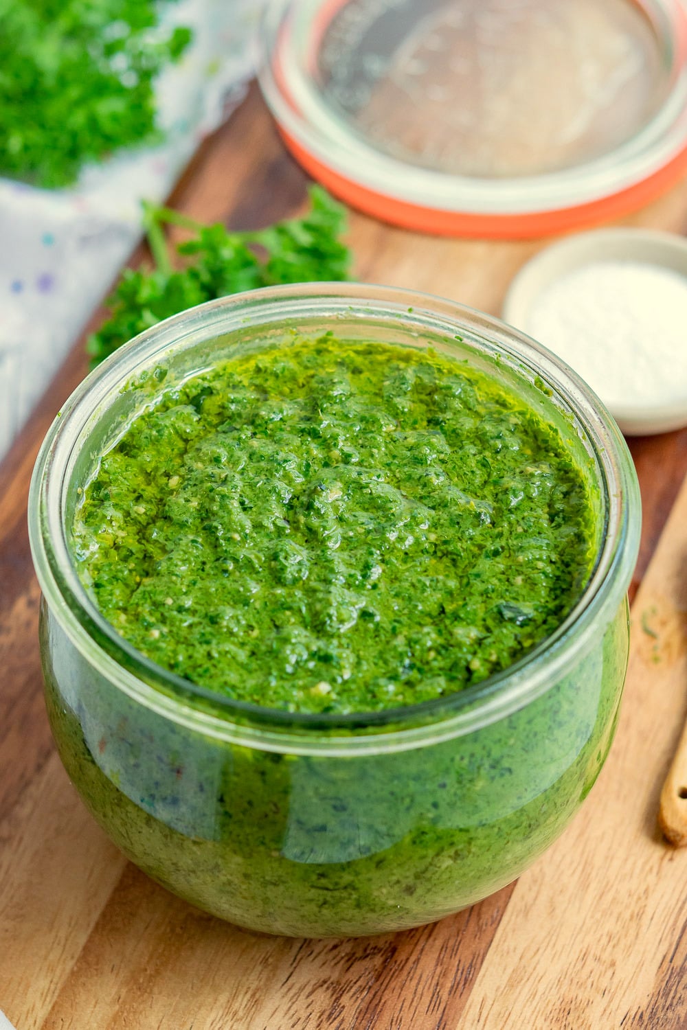 Cheesy Vegan Pesto in a glass jar kept on wood board