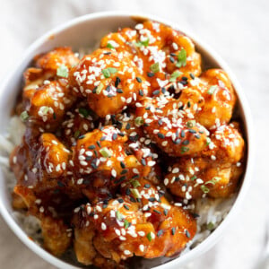 Vegan Sticky Sesame Cauliflower over rice in a white bowl