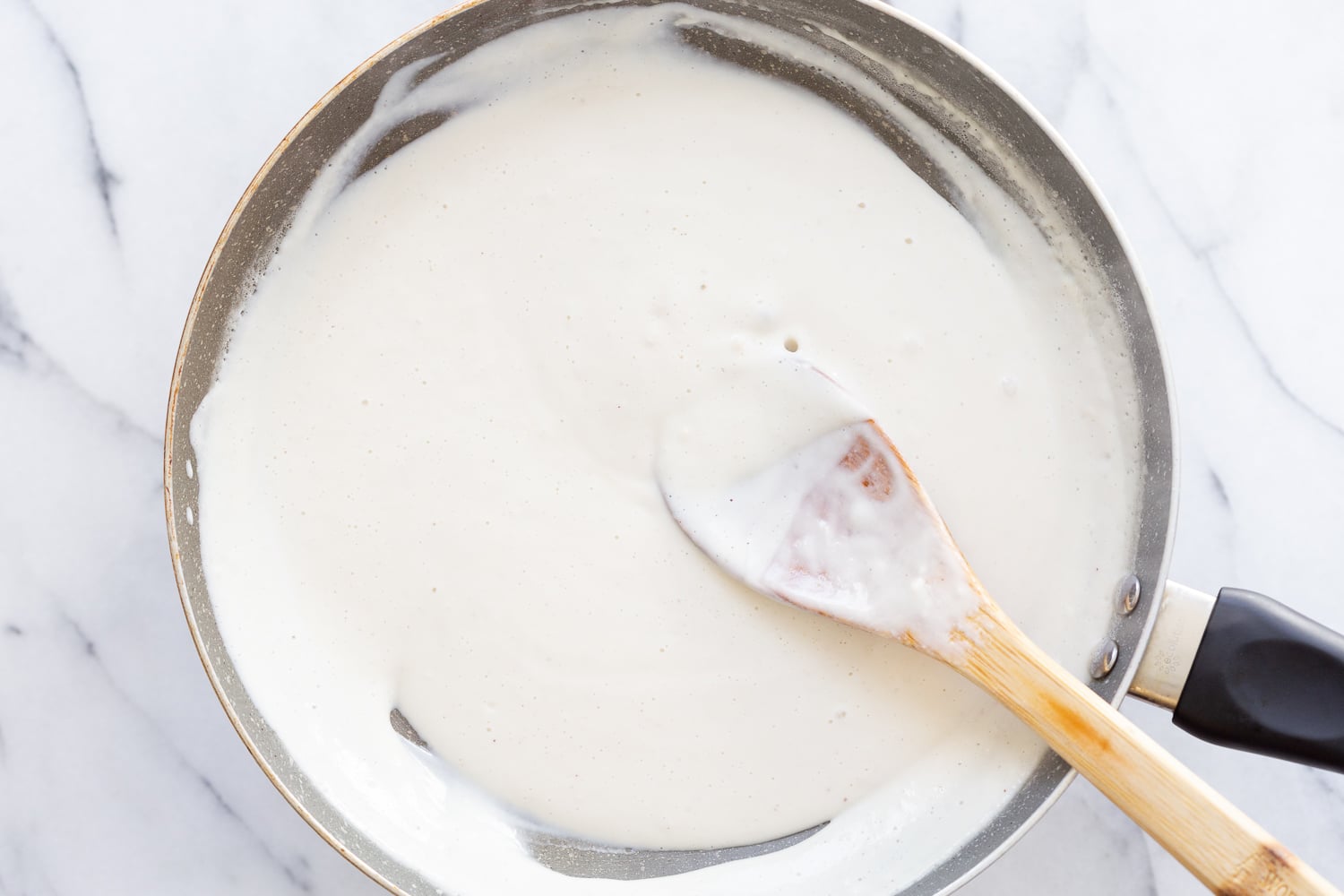 Cashew Mozzarella for our Vegan Mushroom Quesadilla, in a grey pan