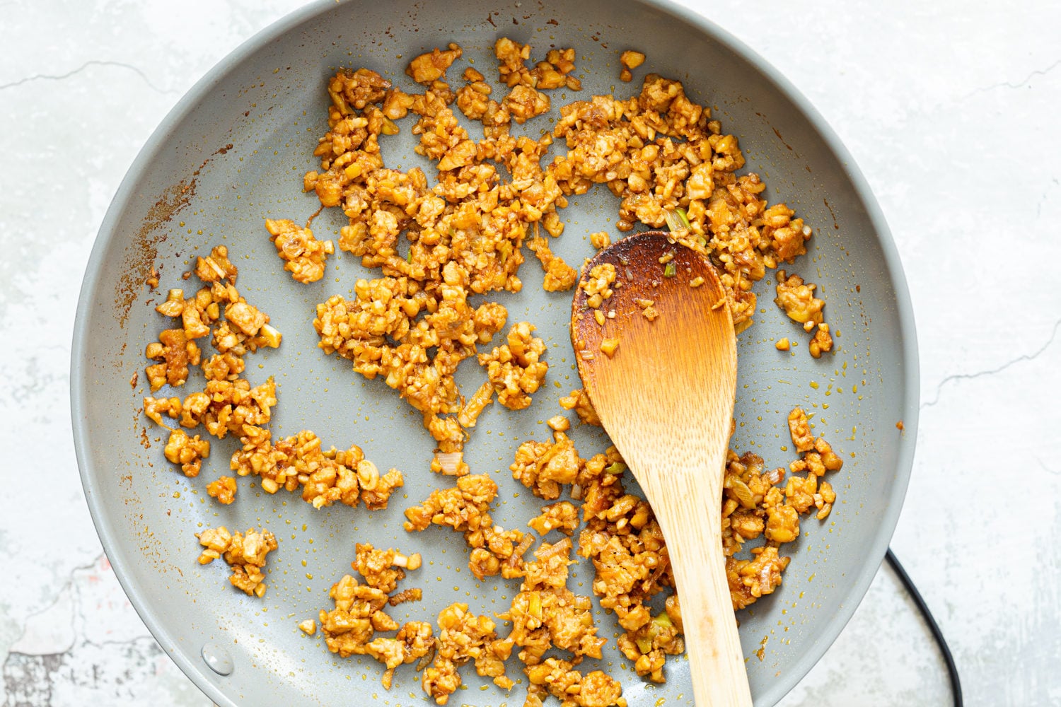 Our Lemongrass tempeh crumbles in grey skillet