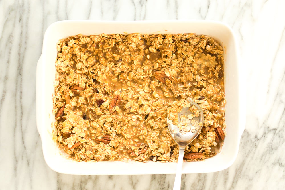 Mixture for Vegan Gingerbread Baked Oatmeal in a white baking dish
