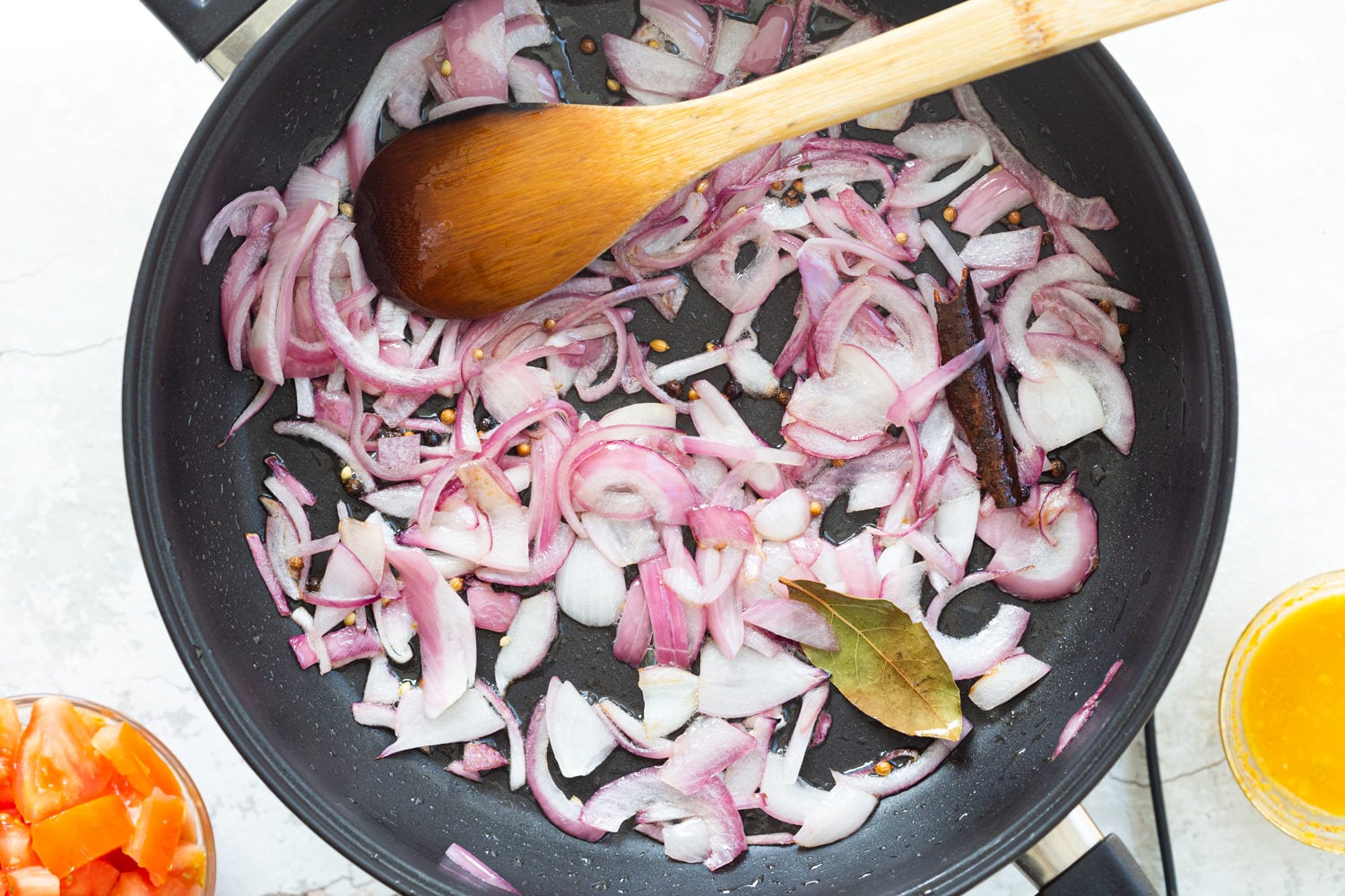 Onion and spices for Kohlapuri sauce in black skillet