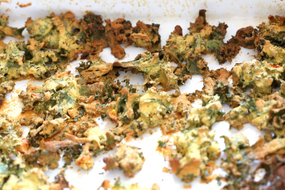 kale pakora in white baking dish