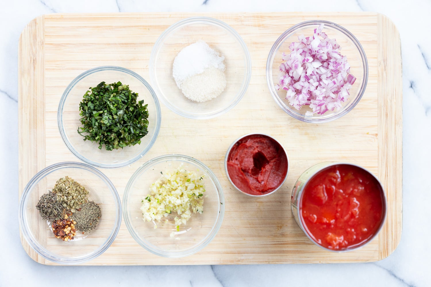 Ingredients for chunky marinara sauce in bowls