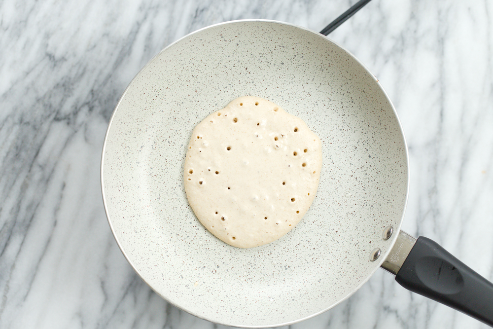 Banana Oat Pancake batter on white stone skillet