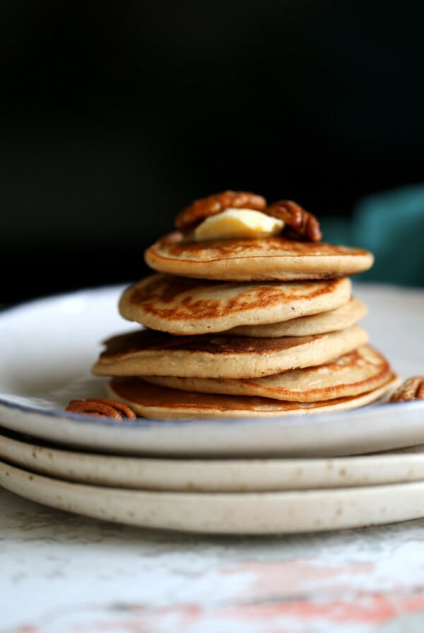 Banana Oat Pancakes Stacked on white plates