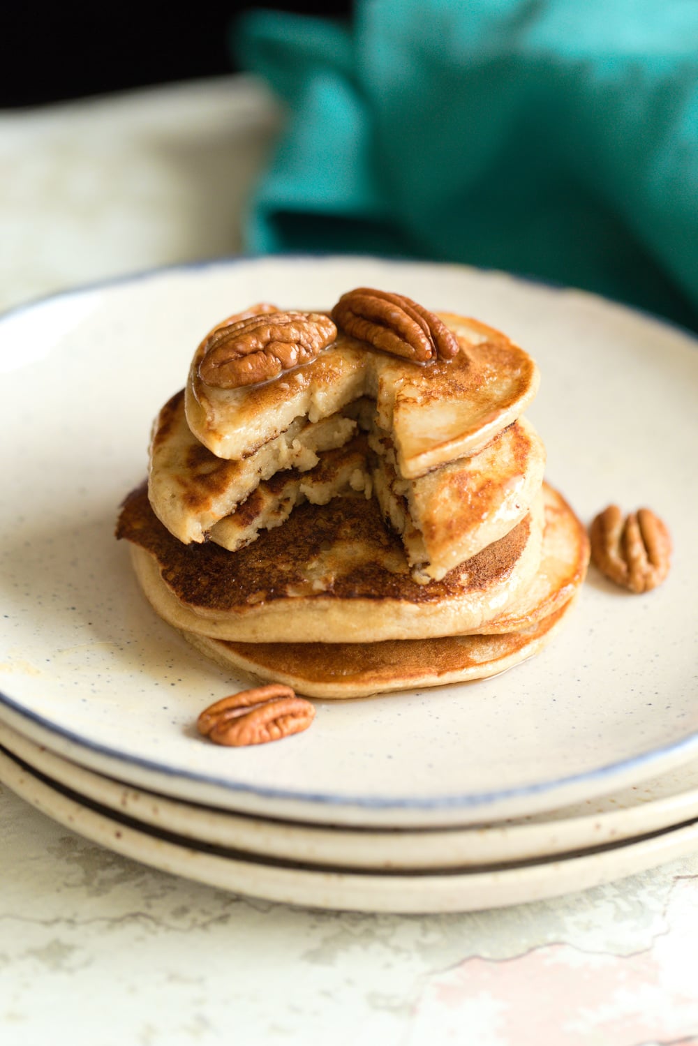 Vegan Banana Oat Pancakes Stacked on white plates