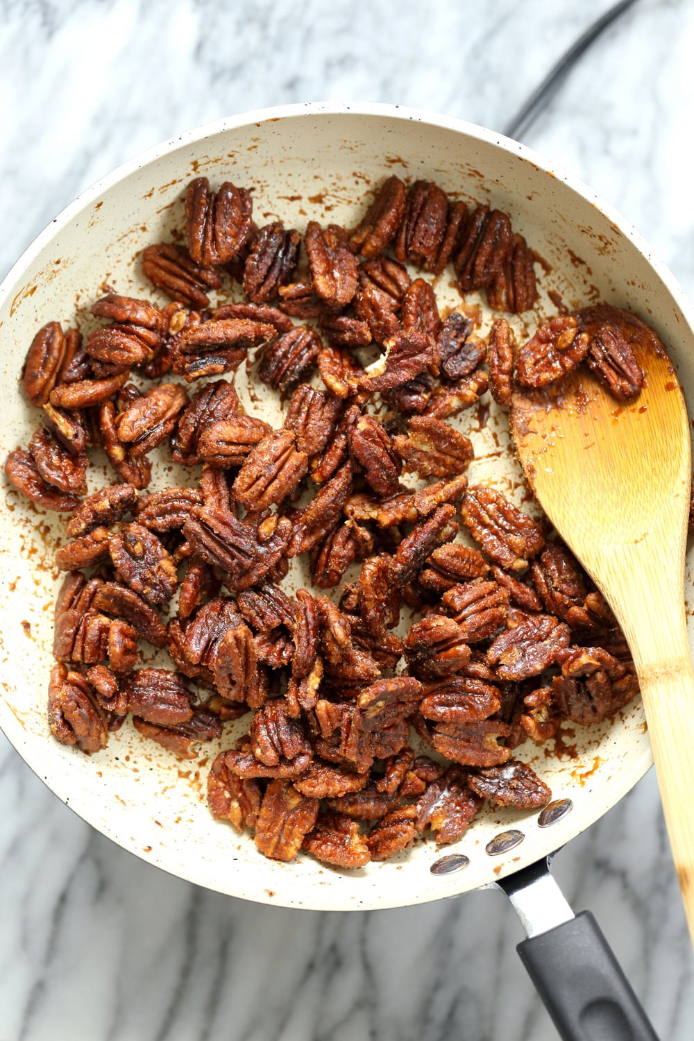 Sticky Pecans in a white skillet