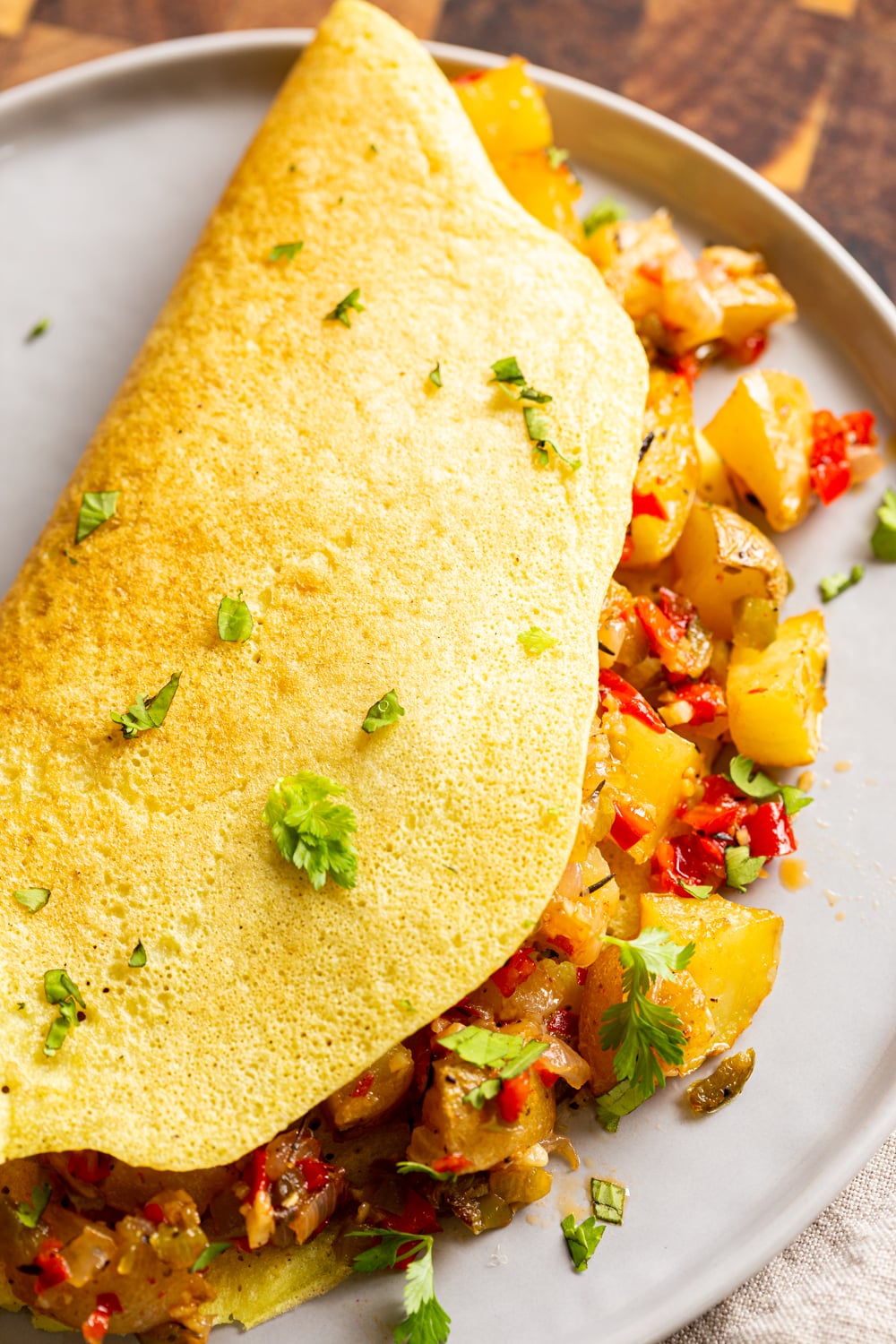 overhead shot of a breakfast omelet filled with vegan baked Breakfast Potatoes