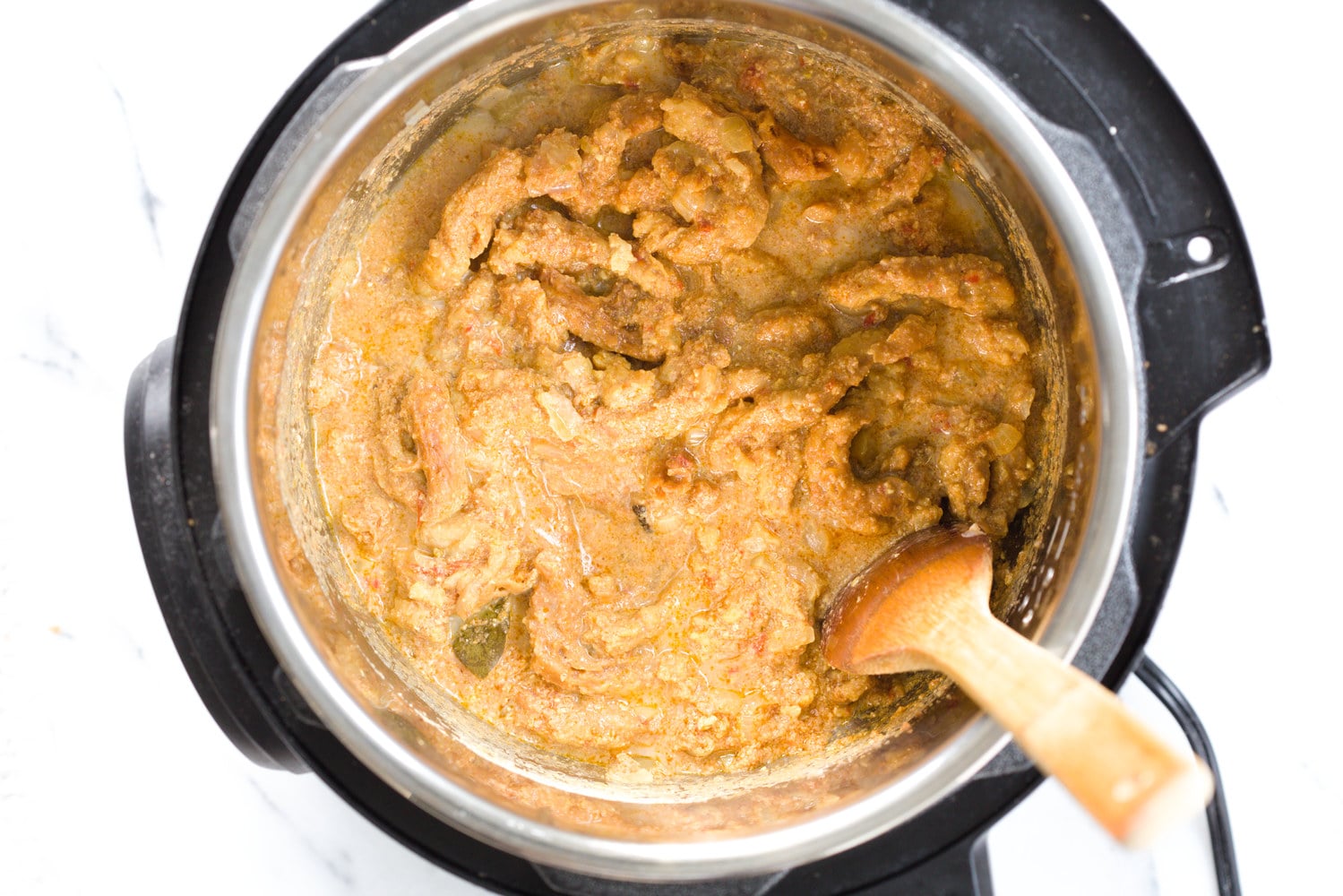 vegan curry recipe vegan creamy fenugreek curry with soy curls being stirred in an instant pot