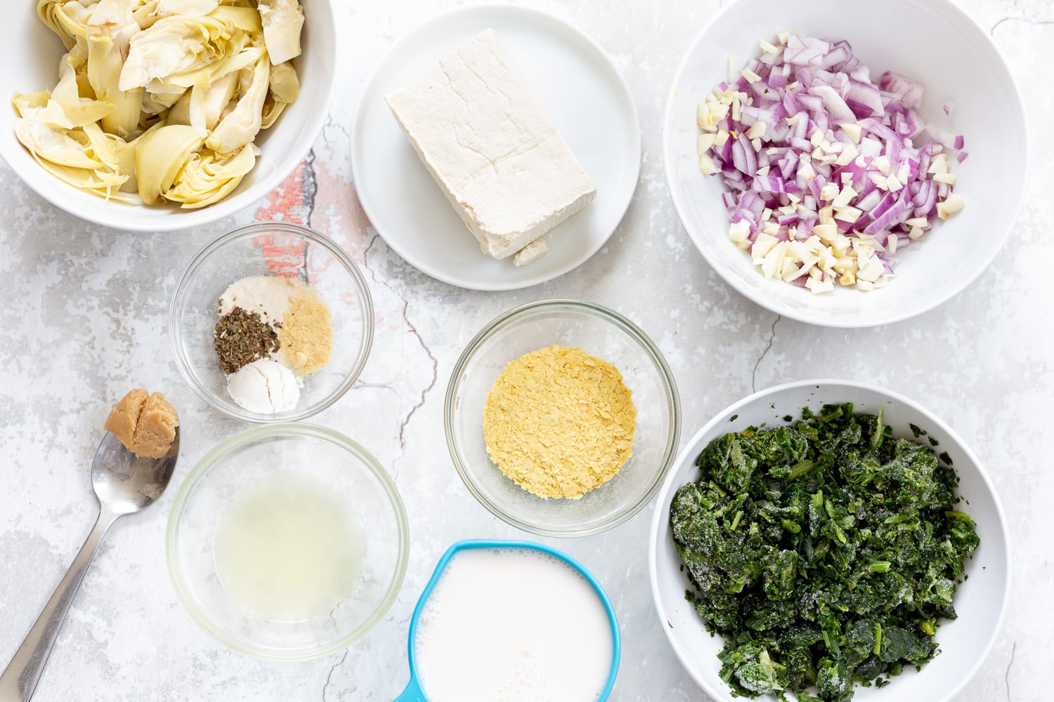 spinach pasta recipe overhead shot of ingredients needed for making spinach artichoke pasta bake