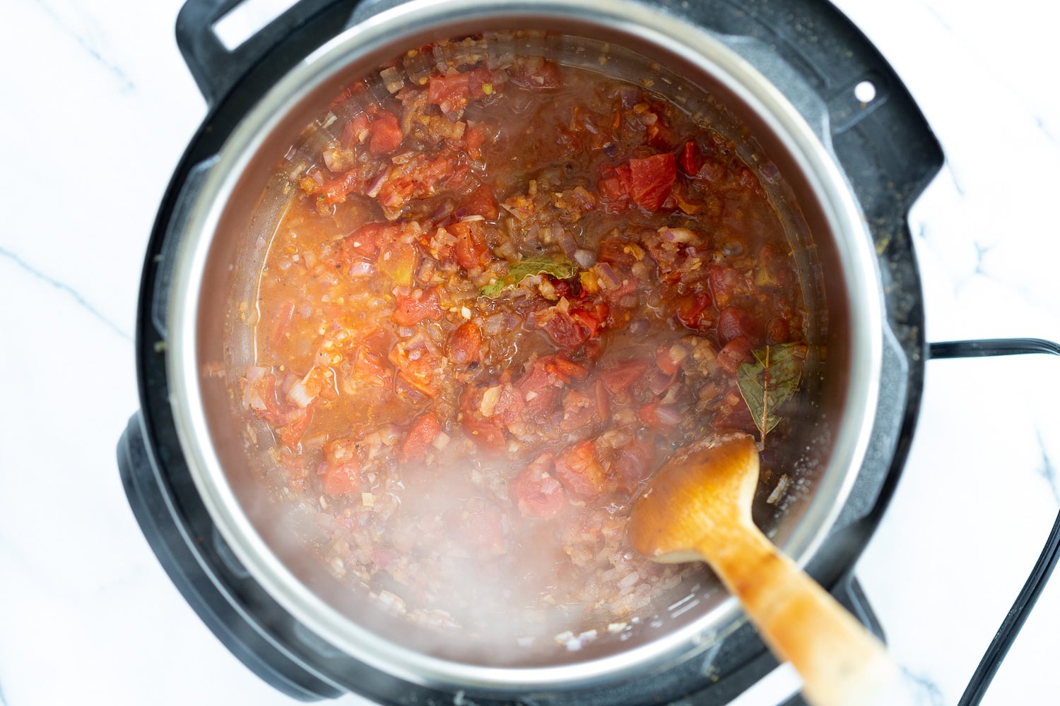 Vegan Black Beans Soup onion, garlic, spices and tomatoes simmering in an Instant Pot