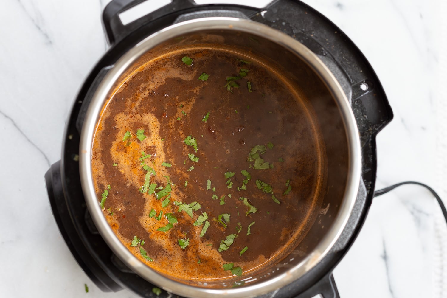 vegan black bean soup overhead shot of vegan black bean soup simmering in an Instant Pot