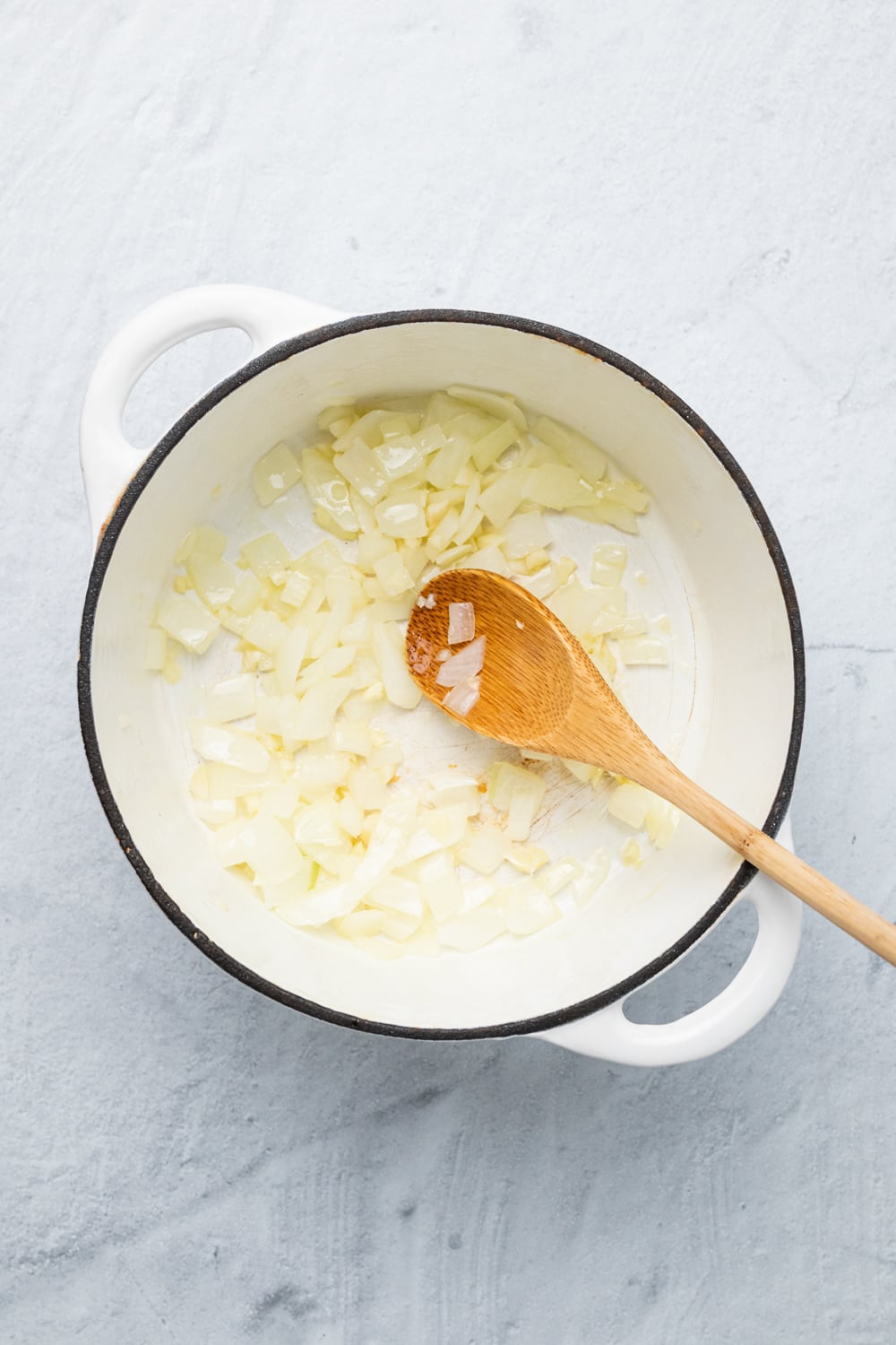 onions being sauteed in a pot 