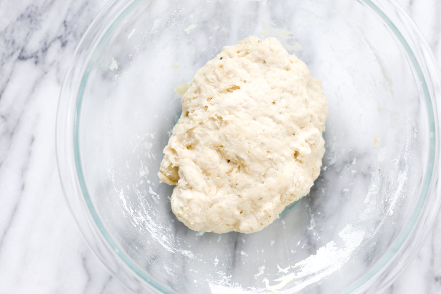 no yeast pizza dough vegan yeast-free pizza dough being mixed in a glass bowl