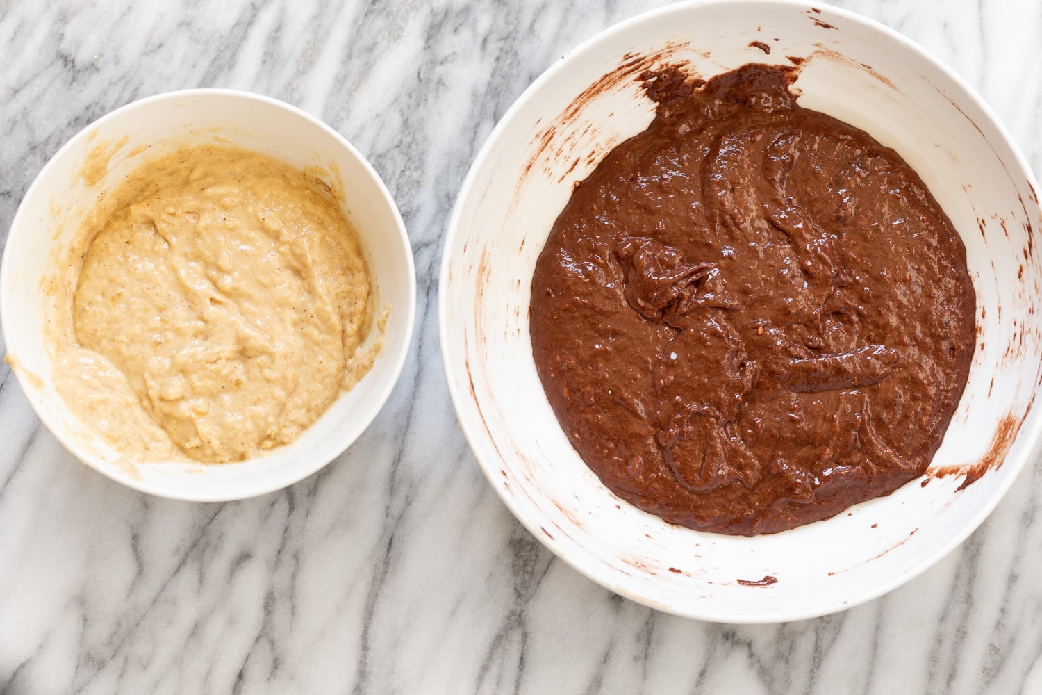 chocolate banana bread dark and bright banana bread batter in two bowl ready to be combined for making marbled loaf