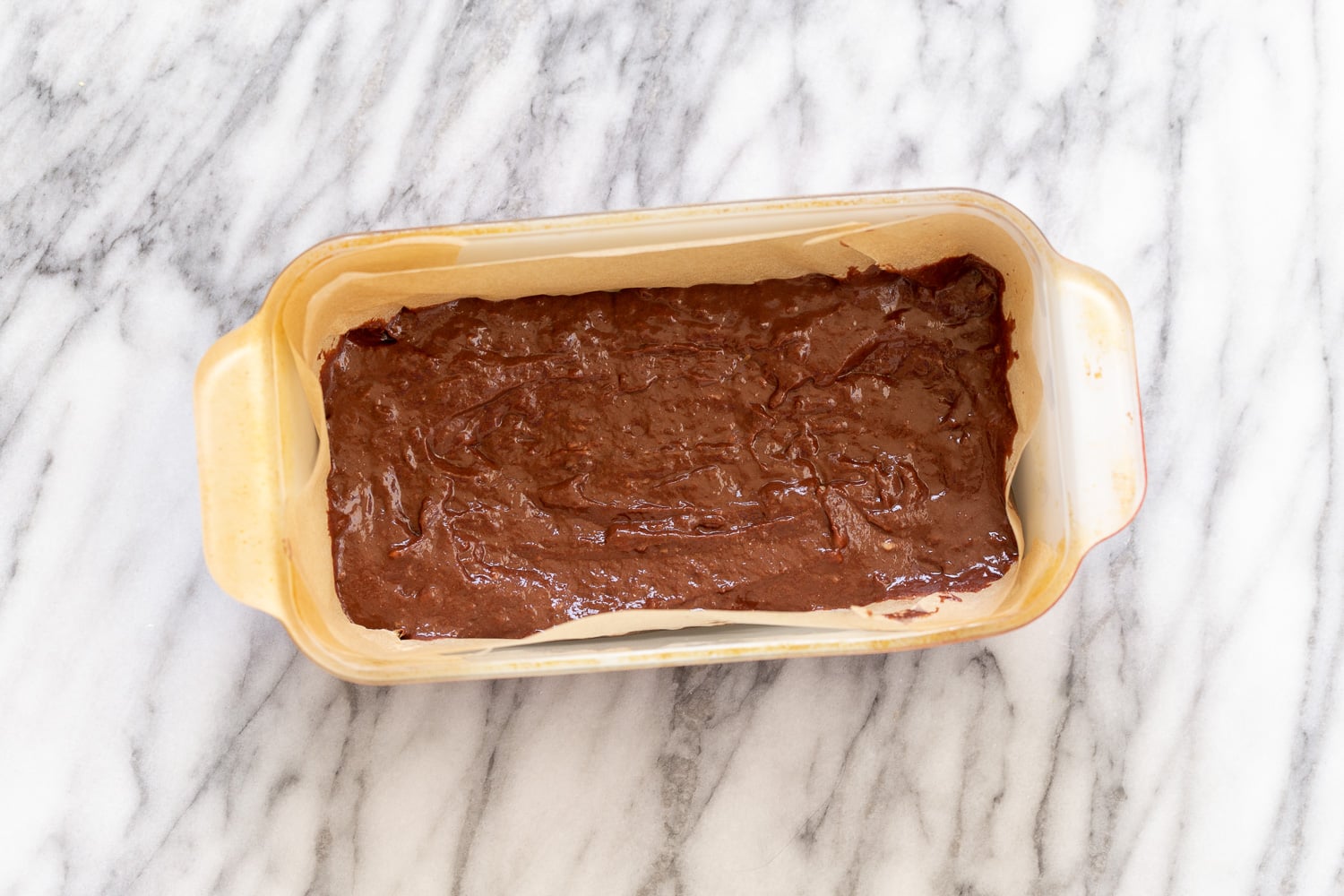 chocolate banana bread overhead shot of a loaf pan with unbaked vegan chocolate banana bread