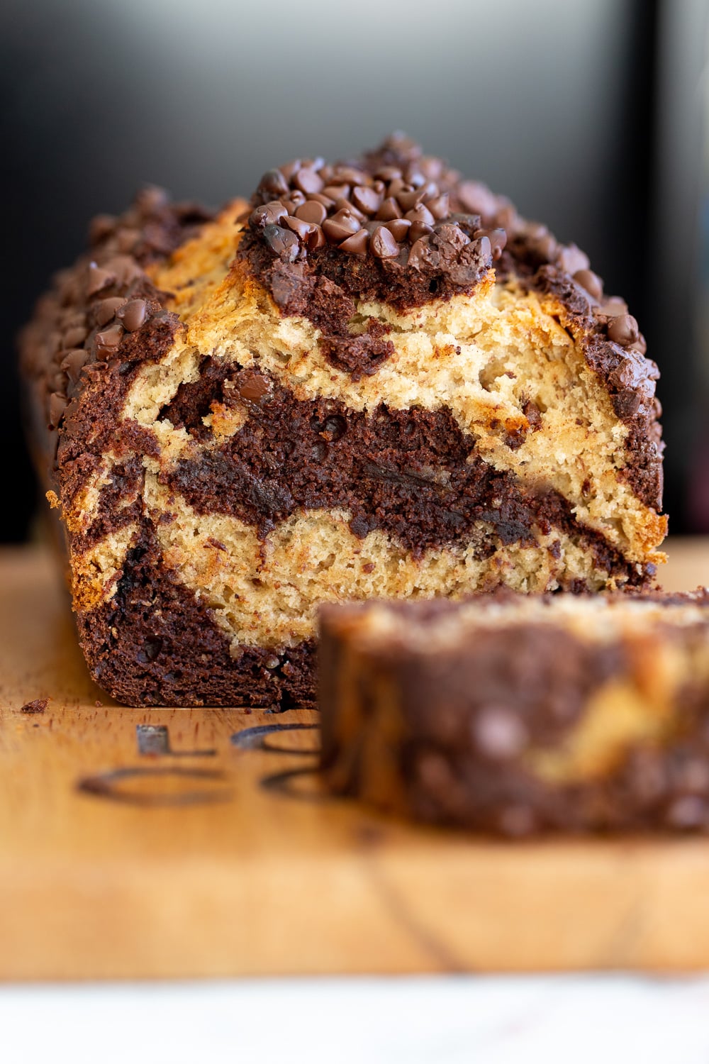 chocolate banana bread side view of a sliced loaf of egg-free and dairy-free vegan marbled chocolate banana bread