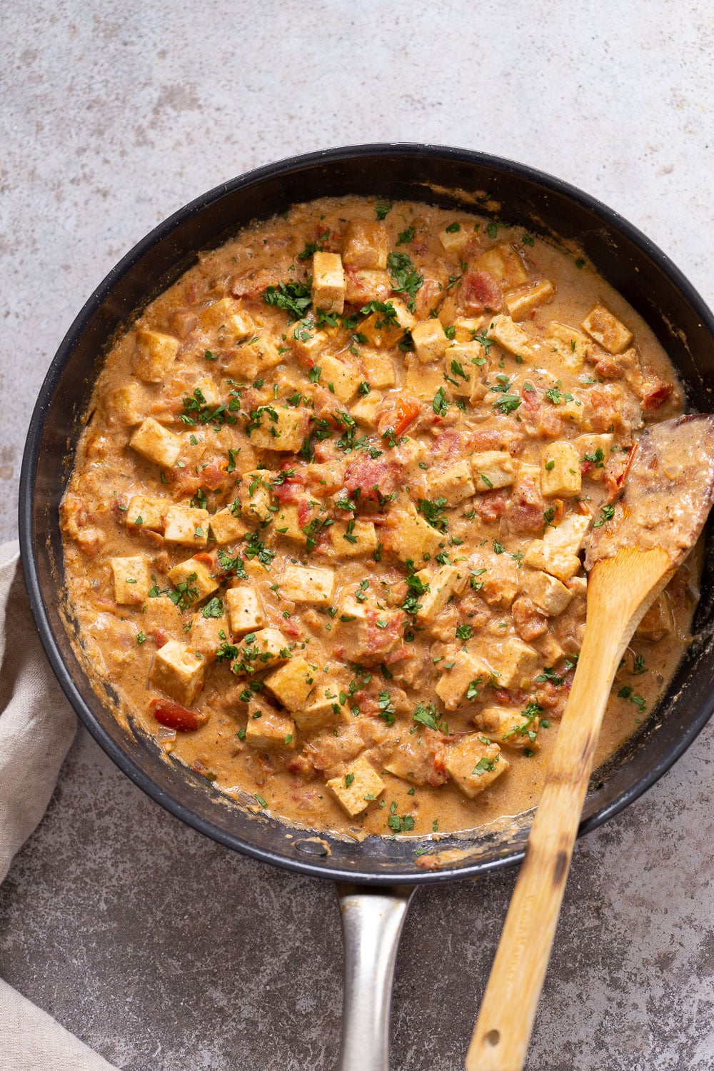 tofu in sauce overhead shot of a skillet with tofu in creamy black pepper sauce