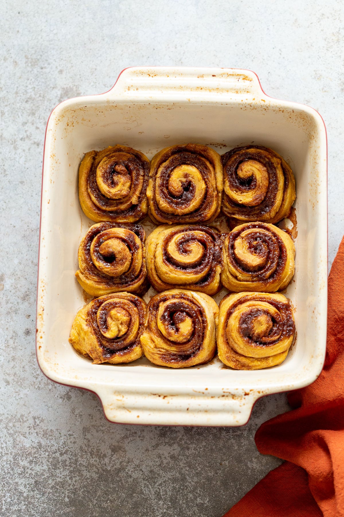 no yeast cinnamon rolls overhead shot of a casserole dish with freshly baked cinnamon rolls