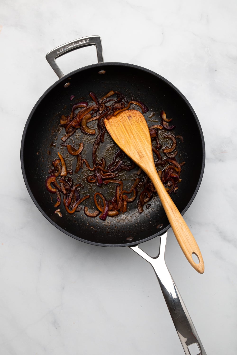 chickpea burger overhead shot of caramelized onion in a black frying pan