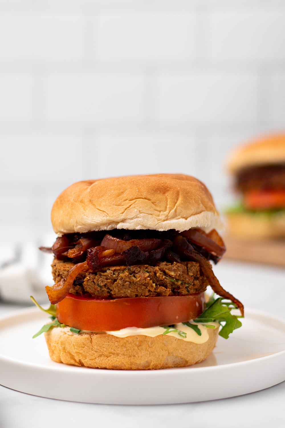 chickpea burger side view of a vegan Middle Eastern Za'atar Spiced Chickpea Burger on a white plate